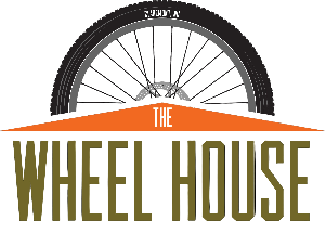 Logo of The Wheel House with a bicycle wheel on a white background